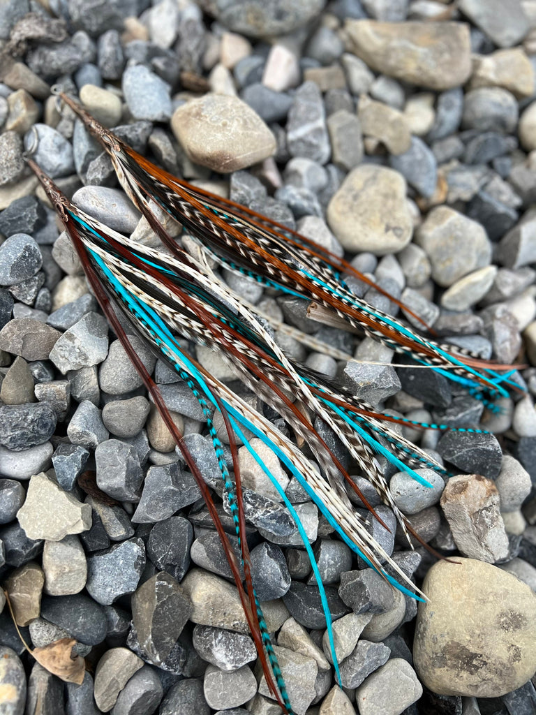Neutral palette with blue grizzly long feather earrings