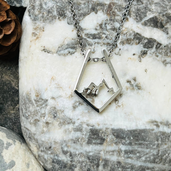 Stainless steel open work mountain scape necklace